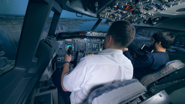 Airplane Pilot Instructor and a Man Are Managing Flight Simulation Process