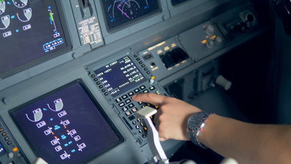 Pilot Is Entering Data Into Airplane Control System