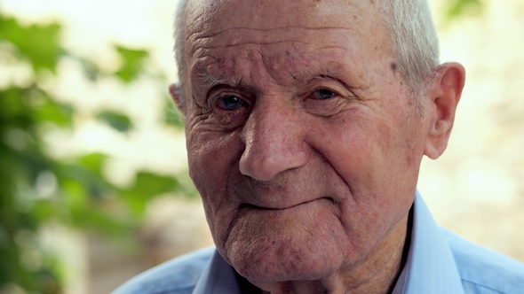 Very Old Man Portrait with Emotions. Grandfather Is Smiling and Looking To Camera. Portrait: Aged