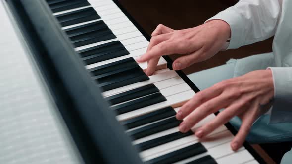 Selective focus to piano key and fingers to play the piano. There are musical instrument for concert