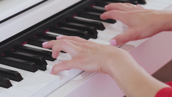 Woman Hands Playing the Piano