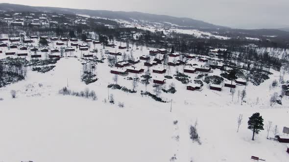 Panoramic orbiting aerial over rural area in snowy winter landscape