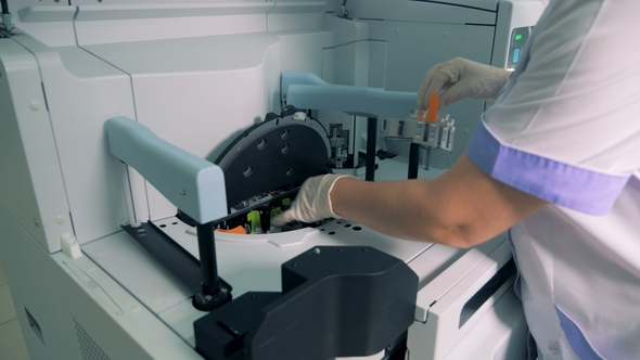 Vials with Samples Are Getting Put Inside of an Analyzing Machine alt