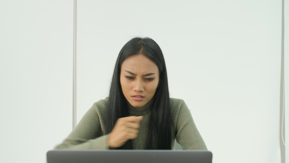 Young Asian Women Getting Very Bad News on His Laptop