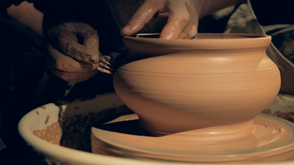 A Craftsman Shaping a Vase with a Fork
