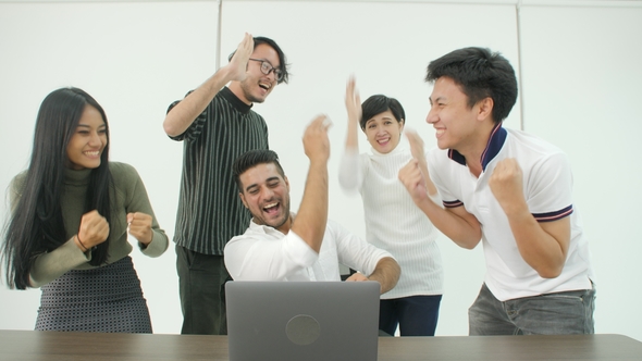 Happy Business Team Looking at Computer