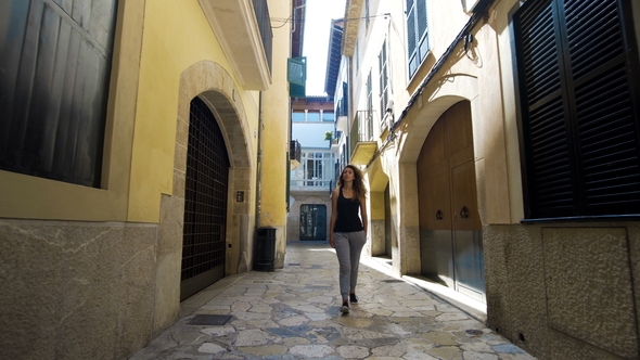 Rear View Tourist Woman Walking Narrow Streets of Barcelona Wearing Cute Summer Dress Enjoying