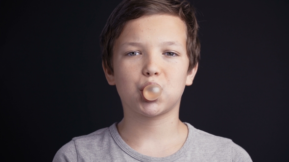 Footage Boy Make Bubble with Chew on Dark