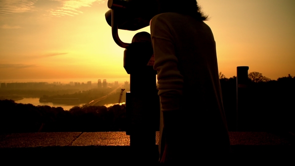 Lady Observing Spectacular Sunrise Over the City