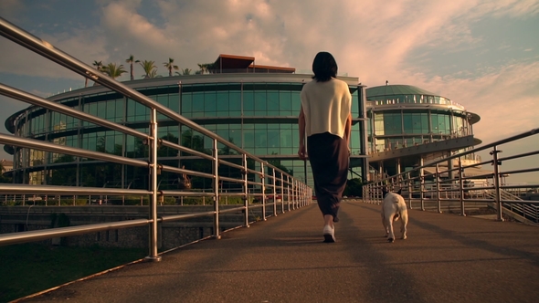 Woman Walking By the Ballustrade with Her Pet