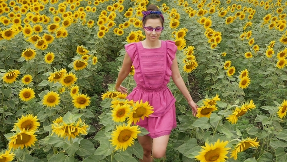 Girl in Pink Dress Walking on the Field