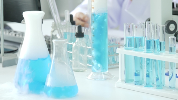 Blue Chemical Substance With Smoke Boils In Laboratory