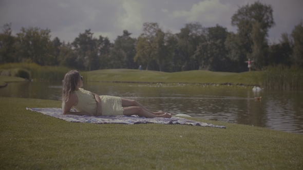 Elegant Pretty Woman Resting in Summer Park