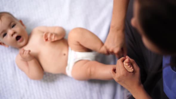 Mom Massages the Feet of a Lying Child