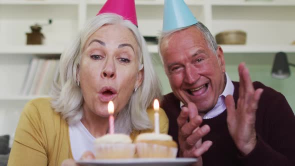 Portrait of happy senior caucasian couple celebrating a birthday