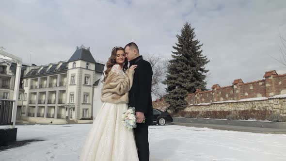 Newlyweds. Caucasian Groom Kisses Bride. Wedding Couple. Happy Family. Winter