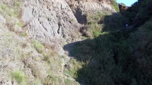 Buttery soft aerial drone flight fly forwards drone shot slowly rise up drone through a canyon cliff