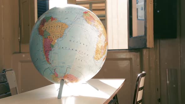 Terrestrial Globe Map in an Empty Classroom. Zoom Out.