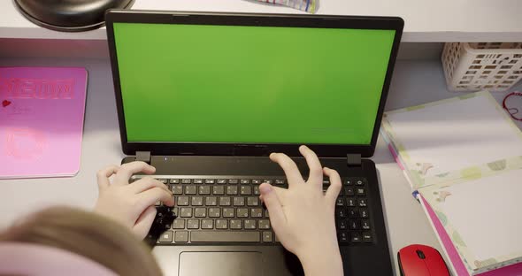 Teenage Girl Studying at Home on Laptop with Green Screen at Home