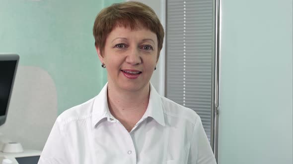 Woman Doctor Smiling and Looking To the Camera