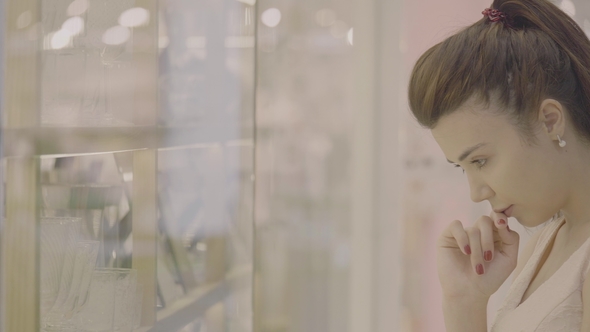 Showcase of Retail Store and Woman Choose a Goods