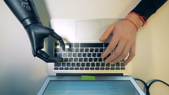 Laptop Keypad Getting Typed on By a Robotic Cyborg Arm