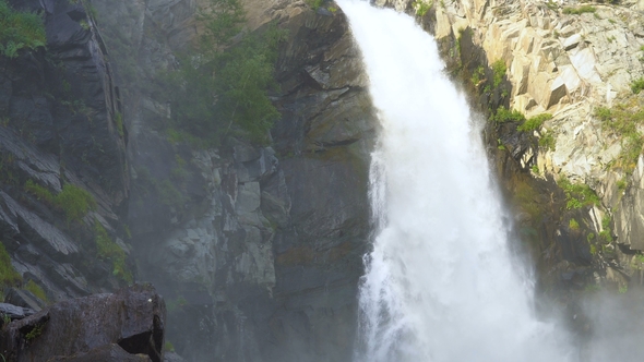 The Traveler Stands Next To the Waterfall.