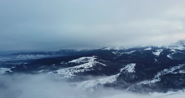 Epic Aerial Flight Near Mountain Clouds Towards Sunrise. Picturesque and Gorgeous Scene