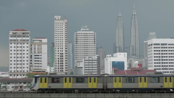 View of Train on the Foreground and Modern Buildings Skyscraper on the Background. Kuala Lumpur