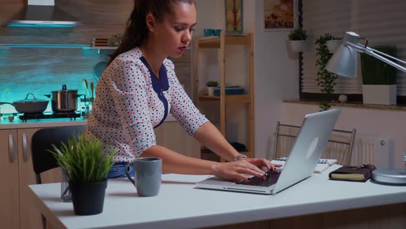 Woman Checking Watch Closing Laptop and Leaving