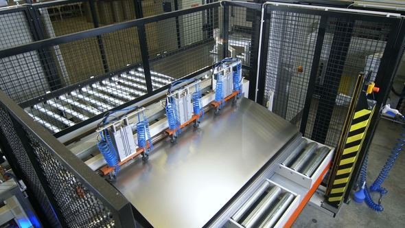 Upper View Automatic Machine Takes and Transports Metal Pieces