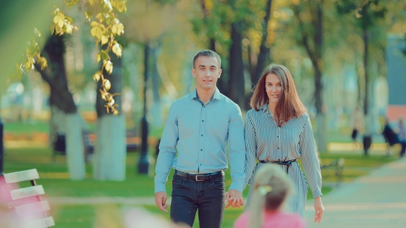 Young Happy Couple Walking in Beautiful Summer Park