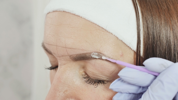 Application of Anesthesia Cream. Permanent Makeup. Permanent Tattooing of Eyebrows.