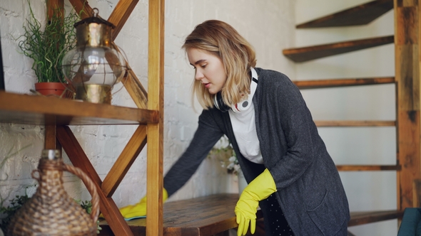 Professional Housekeeper Is Dusting Furniture with Wet Cloth