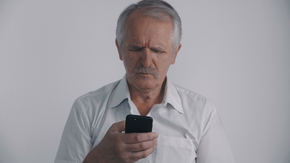 Portrait of Senior Man with Mustache Using Smartphone at White Background