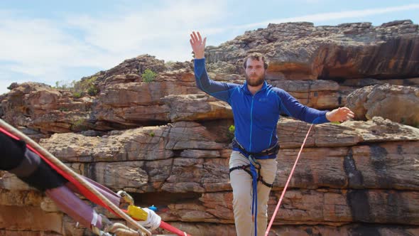 Mountaineer starts walking on the tightrope