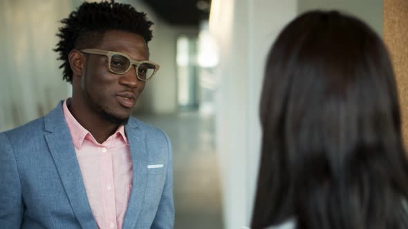 Thoughtful African American Man Talking with Colleague