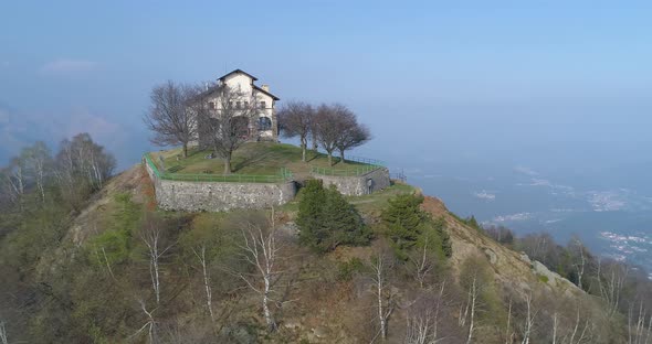 Aerial View of Mountain Peak During Autumn During Day with Building on Top