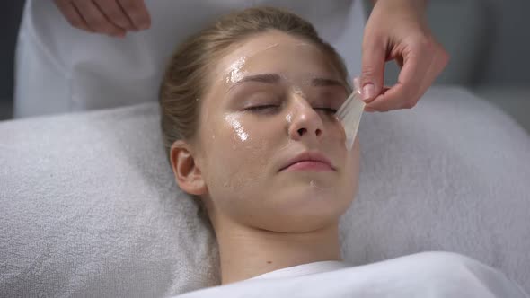 Beautician Removing Remains of Mask From Girls Face, Deep Cleaning of Pores