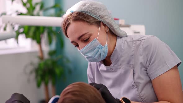 Two Woman Doctors in a Dental Clinic Serve the Patient Little Boy