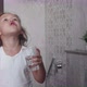 Little curly child girl rinses her mouth with water. - VideoHive Item for Sale