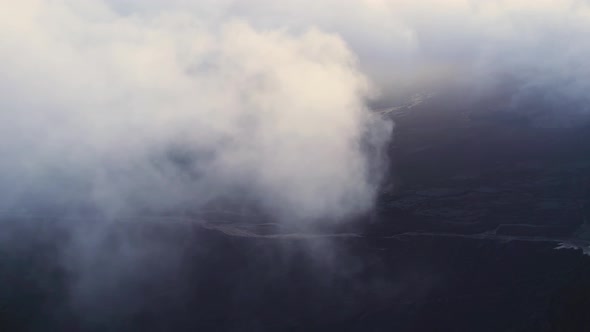 Mountain surrounded by clouds in evening