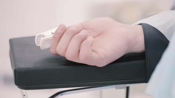 Human hand with a sensing device connected to it