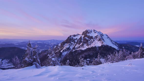 Colorful winter rocky mountain in beautiful wild snowy nature at sunset, time lapse video