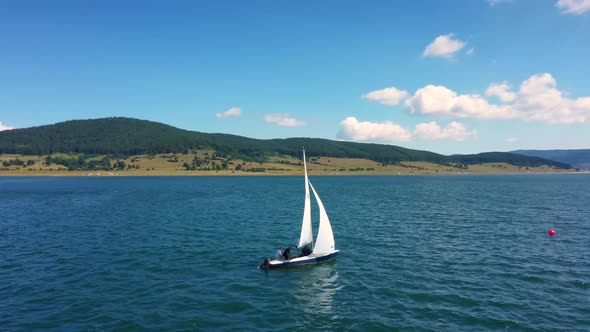 Bird Eye View Of Luxurious Sailboat Sailing On The Forest Lake