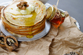 Stack of pancakes on a paper napkin, served with honey and walnu - PhotoDune Item for Sale