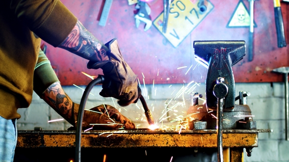 Metalworking Industry - Worker Welding Metal at Garage