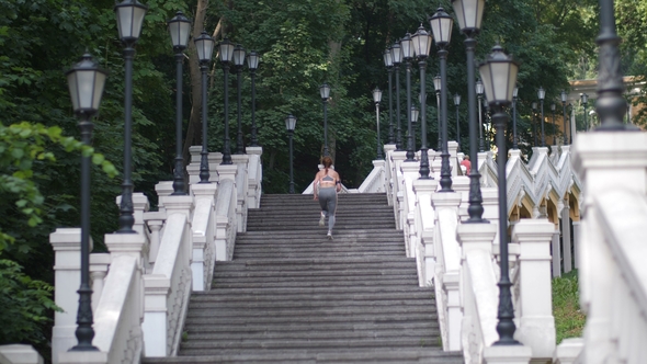 Athletic Woman Running Up the Stairs in the Park