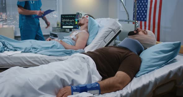 Doctor and Nurse Visiting Injured Soldiers in Hospital