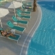 Beautiful Girl Lies on a Lounger By the Pool - VideoHive Item for Sale